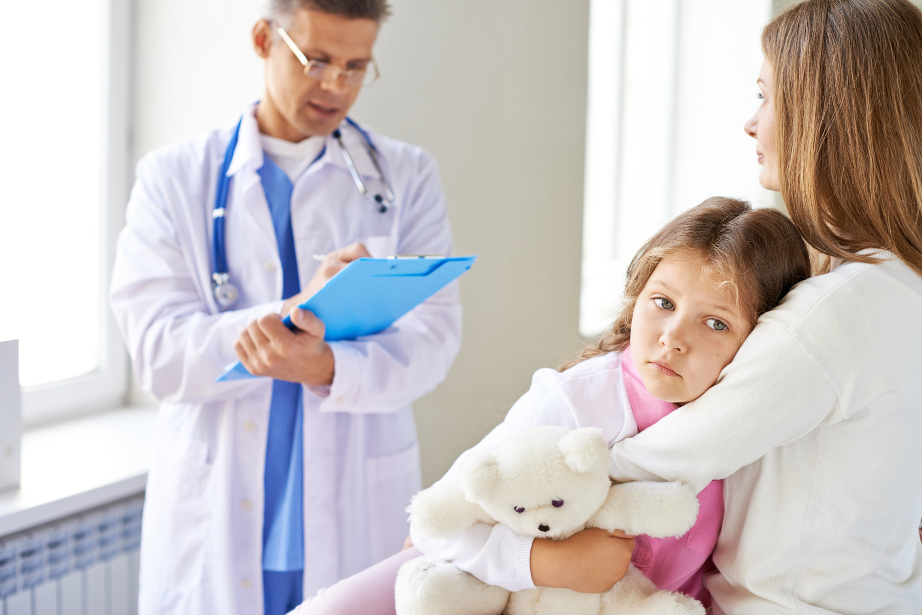 Sad girl and her mother visiting doctor in clinics